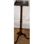 An Edwardian mahogany lampstand in Chippendale style, the square top with a pierced fret gallery,