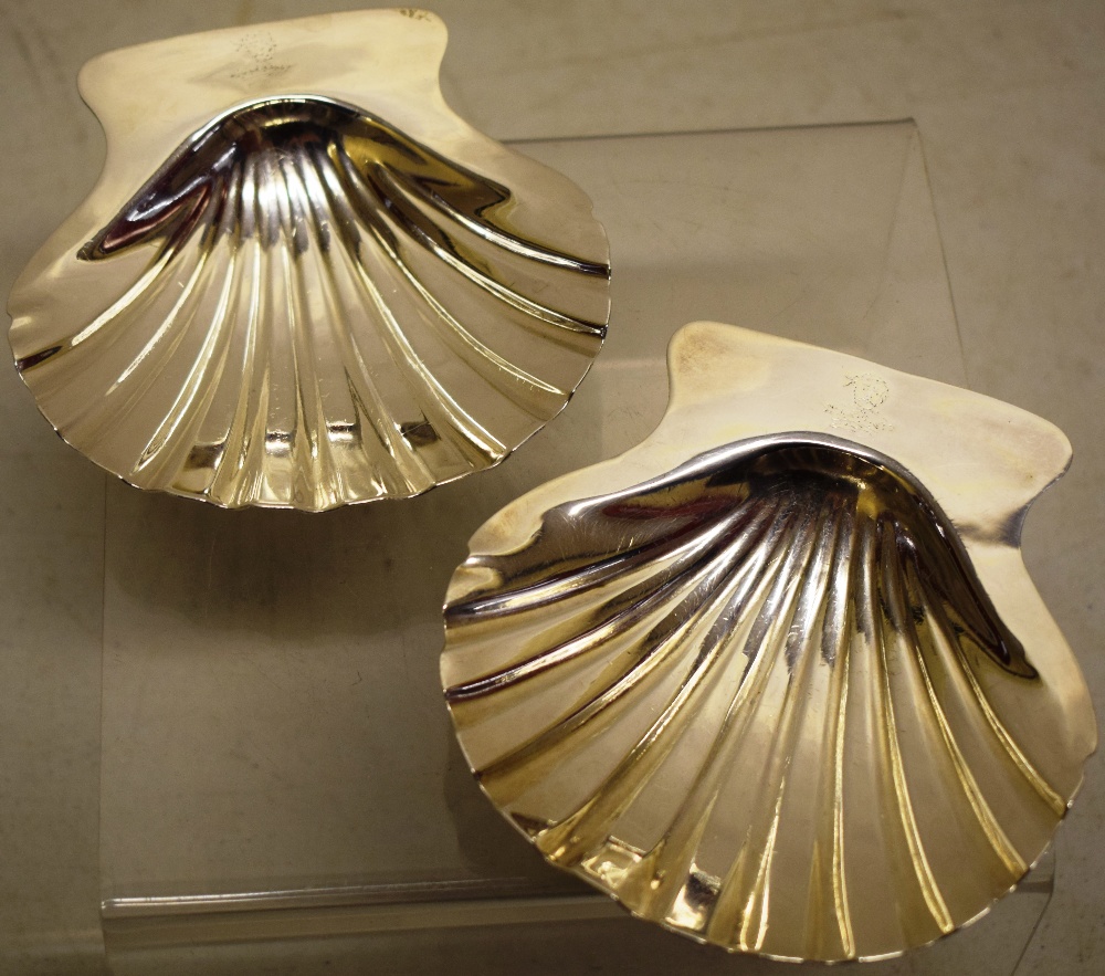 A pair of Regency silver butter shells with crested lifts, on welk feet, Maker Robert Garrard,