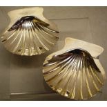 A pair of Regency silver butter shells with crested lifts, on welk feet, Maker Robert Garrard,