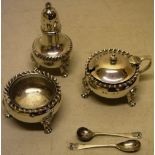 A silver three piece circular condiment set, with gadroon borders, on cast lion mask paw feet, the