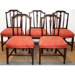 A set of five Sheraton mahogany side chairs, with rail and splat backs, 'H' stretchers and stuffed