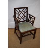 A George III stained beech cockpen elbow chair, with trellis work back and arms, the drop in seat on