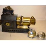 A Victorian magic lantern, the brass barrel inscribed, Riley Bros. Ltd, Bradford, 17in (43cm) with a