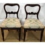 A pair of early nineteenth century carved beech side chairs, the open buckle backs with foliage