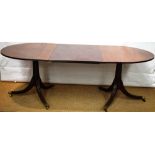 A mahogany twin pillar extending dining table, the two 'D' ends united by an extra leaf, inlaid