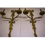 A pair of Neo Classical design ormolu wall lights, with ribbon tied tassel backs, with scroll
