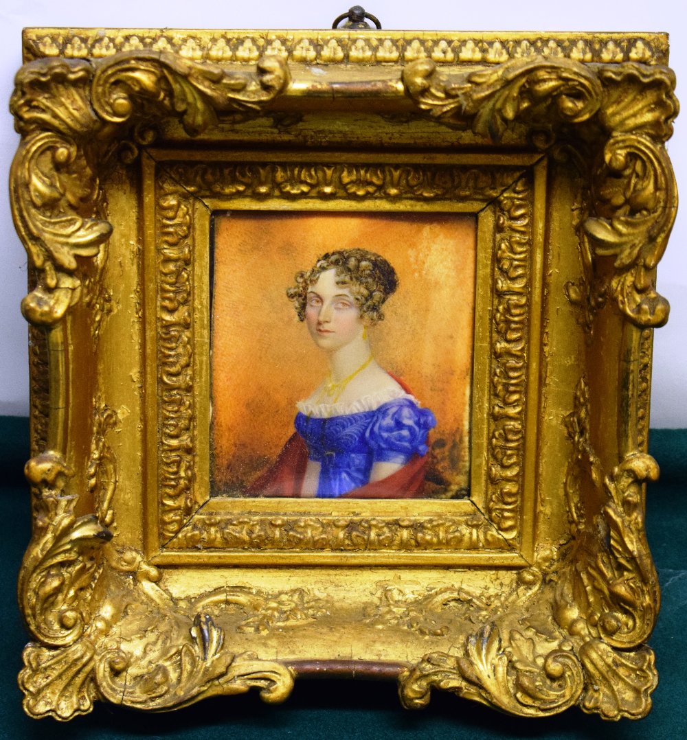 An early nineteenth century Irish miniature portrait on ivory of a young lady wearing a blue