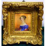An early nineteenth century Irish miniature portrait on ivory of a young lady wearing a blue