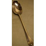 A George II silver basting spoon, hanoverian pattern, engraved a crest of a stags head, 12.5in (