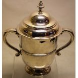 A Queen Anne silver cup and cover, the bell shape body with a girdle moulding, having two capped