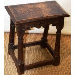 A seventeenth century oak joined stool, with a later seat, the shaped outline friezes on ring turned