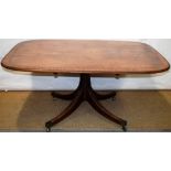 A Regency mahogany breakfast table, the rectangular tilt top cross banded in satinwood, with