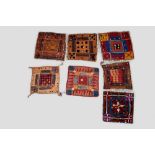 Seven Banjara square cushion covers, north India, mid-20th century, all trimmed with cowrie