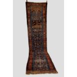Hamadan runner, north west Persia, early 20th century, 14ft. 11in. X 3ft. 6in. 4.55m. X 1.07m.