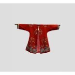 Chinese lady's informal robe, 19th century, red silk satin finely embroidered with three roundels of