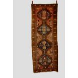 Sarab long rug, north west Persia, early 20th century, 8ft. 1in. X 3ft. 2in. 2.46m. X 0.97m. Some