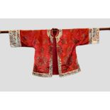 Chinese red silk satin informal robe, first half 20th century, embroidered in coloured silks and