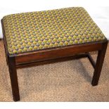 A Georgian style mahogany rectangular stool, the drop in seat covered in patterned needlework, the
