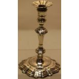 A George II cast silver taperstick, the spool shape holder with a detachable nozzle, a gadroon lapit