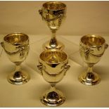 A set of four Edwardian silver wine goblets, in the Adam taste, the bowls with repousse swags