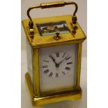 A late nineteenth century brass cased carriage clock with an eight day repeating movement striking