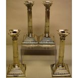 A set of four silver candlesticks, the stop fluted stems with Corinthian capitals and detached