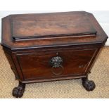A Regency mahogany wine cooler, sarcophagus shaped with ebony mouldings, the lid on hinges reveals a