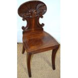 A Regency mahogany hall chair, with scallop shell carved back, a line border to the well figured