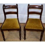A pair of William IV mahogany children's chairs, the bar backs with leaf carving, the green padded