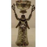 A late nineteenth century German silver wager cup, of a lady courtier wearing a ruff to her winged