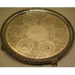 A Victorian silver salver, engraved a circle of panels of grapes and flowers linked by foliage,
