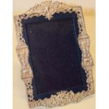 A Victorian silver photograph frame, the back with dark blue plush and covered in black leather,