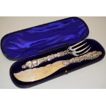 An unusual pair of Victorian silver fish servers, the scimitar shape blade engraved fish swimming