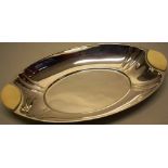 A German art deco oval .800 standard silver coloured metal bread dish, with ivory lifts, 13in (33cm)