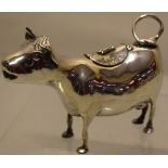 A Dutch silver cow creamer, the back with a hinged cover, engraved flowers and a raised insect, 5.