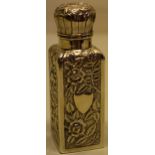 A Victorian repousse silver square perfume bottle, decorated foliage with a hinged cover, a gilded