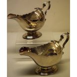 A pair of Edwardian oval silver sauceboats, with fret outline borders, cast leaf capped scroll