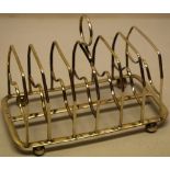 A Regency silver wirework six division toast rack, with a central ring handle, the frame on ball