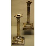 A pair of Victorian silver candlesticks, with stop fluted stems, the corinthian candleholder