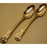 A pair of George IV silver basting spoons, kings hour glass pattern, engraved a padlocked wolfs head