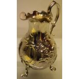 An early Victorian silver milk jug, the pearl shape body with repousse scrolls and foliage, a garter