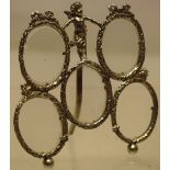 A late nineteenth century continental small silver cast boudoir frame for five oval miniature