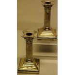 A pair of Edwardian silver dwarf candlesticks, with stop fluted stems, the Corinthian capitals