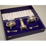 A good quality large silver three piece condiment set with chased Celtic design feet, repeated to