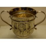 An early George III silver caudle cup, the bell shape body with part fluting and a plumed