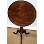 A late eighteenth century mahogany occasional table, the circular tilt top with a raised moulded