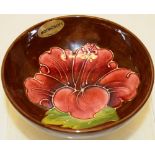 A Moorcroft pattern hibiscus dish, on a foot, 5.5in (14cm) diameter.