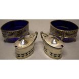 A pair of Victorian silver oval mustard pots, with pierced engraved bands to the sides, the hinged