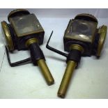 A pair of Victorian patent coach lamps, black painted metal with brass mounts to the glass doors,