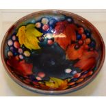 A Moorcroft pattern small vase clemelia, 4in (10cm) and a small footed dish leaves and berries,